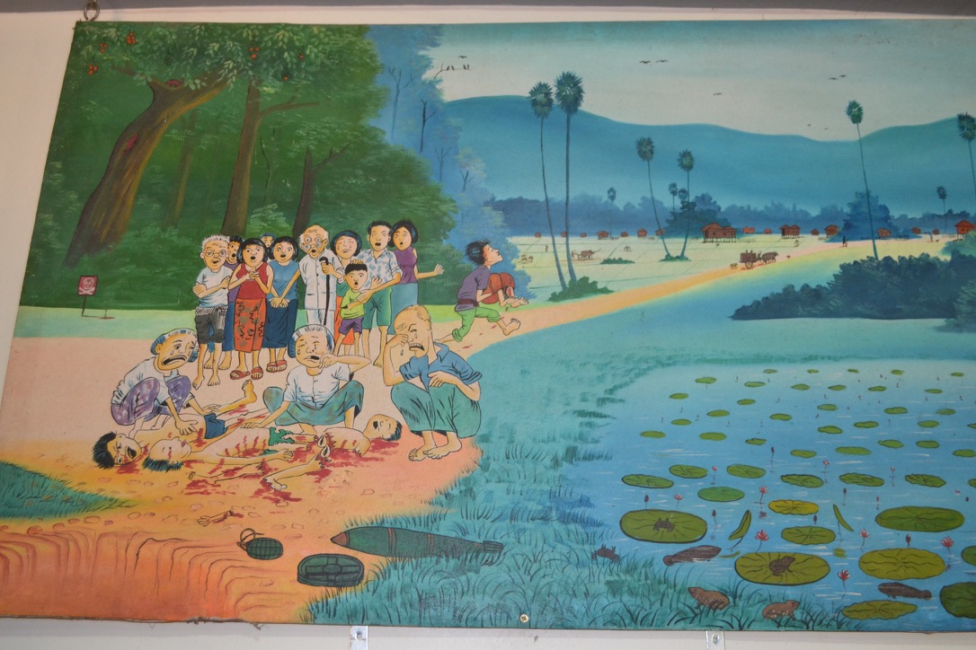 A museum painting of villagers mourning people killed by a landmine on a path beside a lotus pond