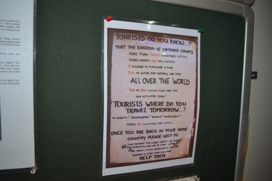 A hand lettered museum poster titled Tourists do you know, listing landmine facts and asking visitors to help